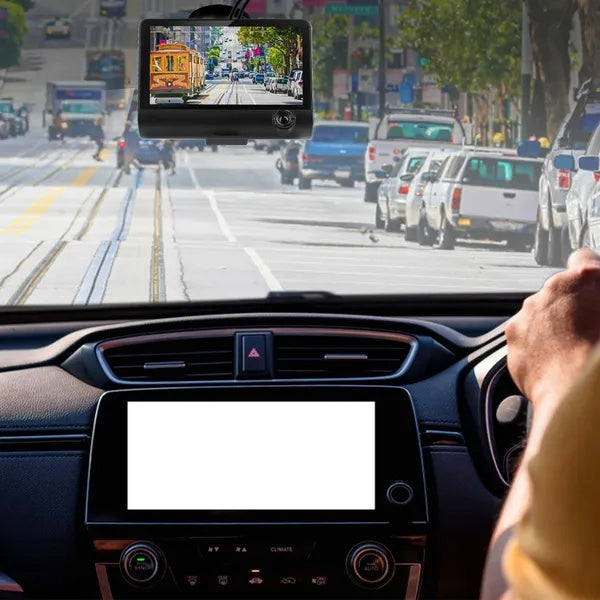 dash camera mounted on car windshield showing busy street ahead and dashboard view.