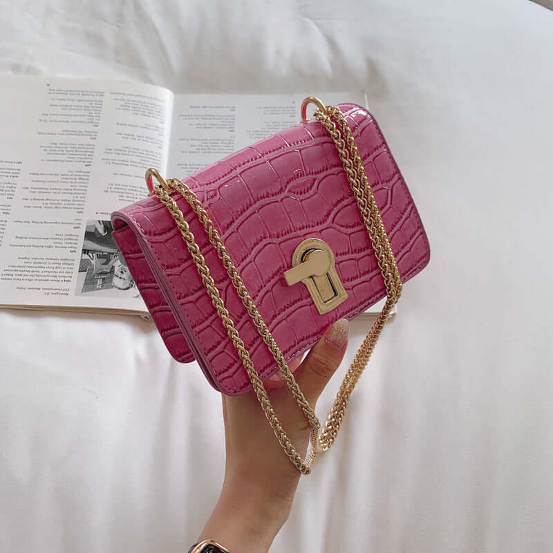 Stylish pink crossbody bag with chain strap, perfect for daily use and casual outings.