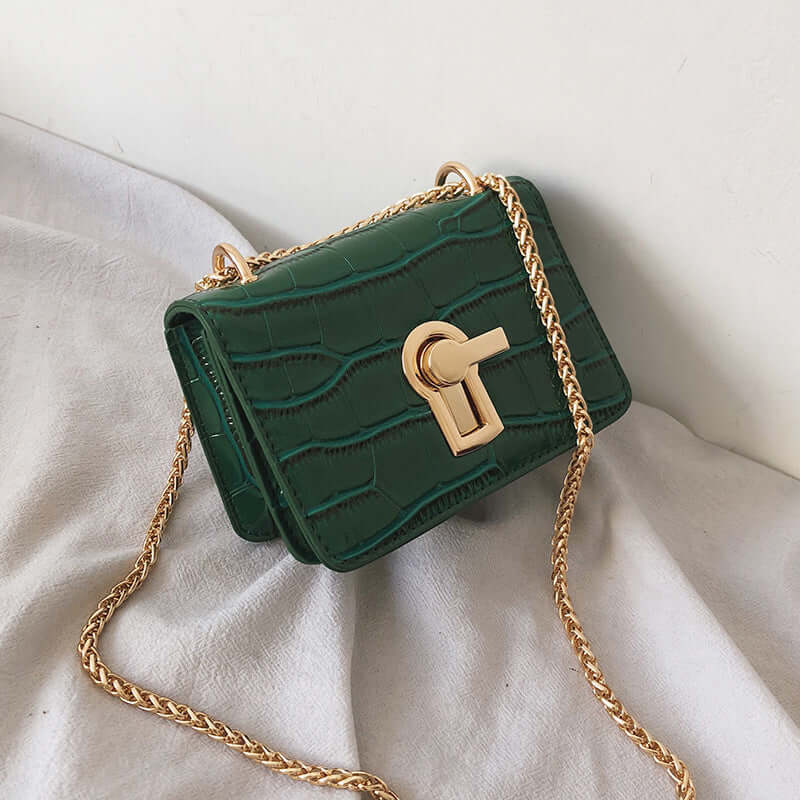 Stylish green crossbody bag with gold chain, perfect for daily use and adding flair to any outfit.