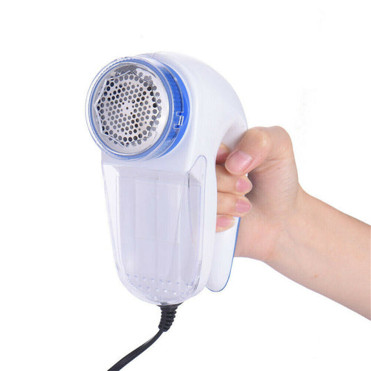 Lint remover and fabric shaver held in hand, convenient for removing fuzz balls from clothes and fabrics.