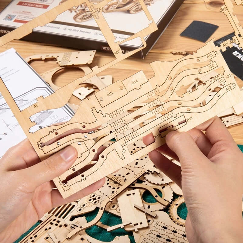 Hands holding wooden pieces of the 3D wooden puzzle model toys MC701 surrounded by assembly materials.