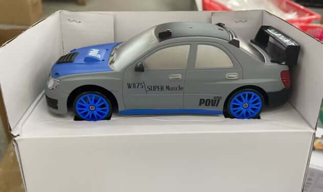 Remote Control Drift Racing Car in a box featuring blue wheels and front LED lights for high-speed fun.