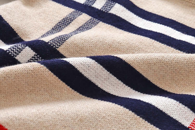 Boys plaid jacquard sweater fabric close-up with soft texture and striped pattern in beige, navy, and white.