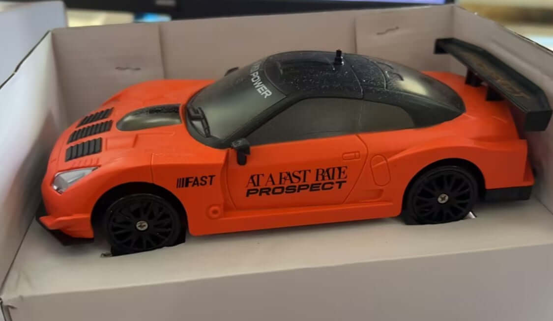 Remote Control Drift Racing Car in an orange design inside its packaging.