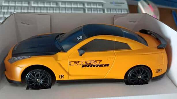 Remote Control Drift Racing Car in box showcasing its sleek design and vibrant yellow color.