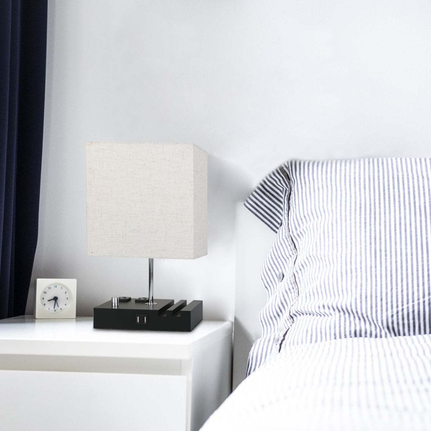 Fully dimmable table lamp with USB ports and power outlets on bedside table.